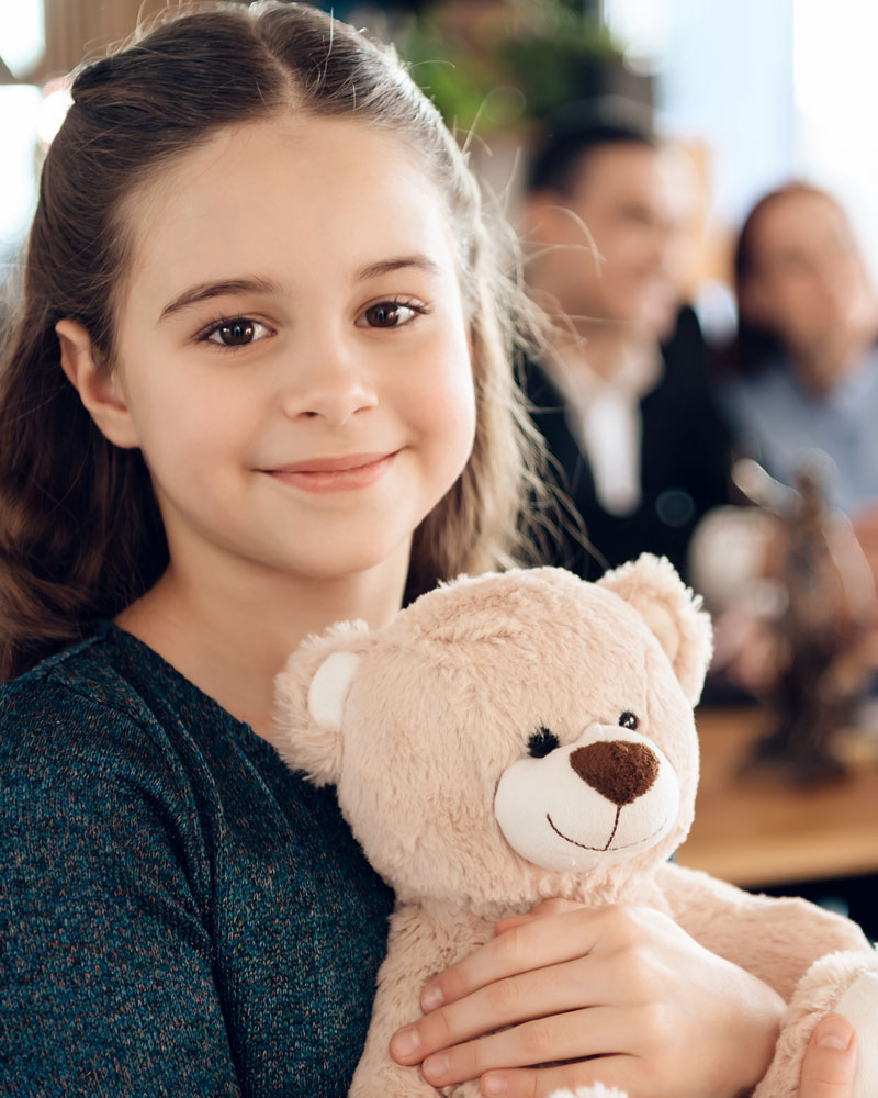 child holding a teddy bear